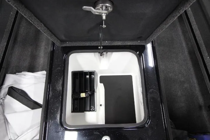 Slide: The Image of 2026 BassCat Cougar FTD SP storage compartment with open lid and latch mechanism. - 9