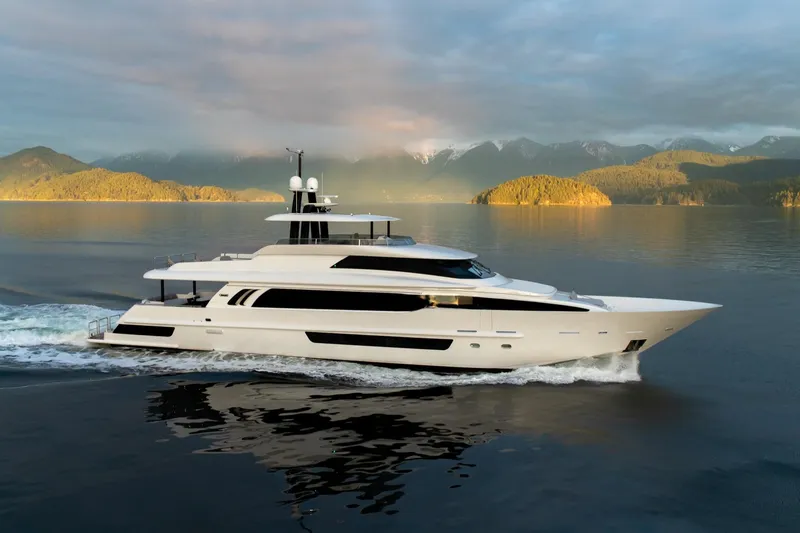 The Image of Luxurious 2019 Crescent Semi-Displacement yacht cruising on serene waters with scenic mountain backdrop. - 1