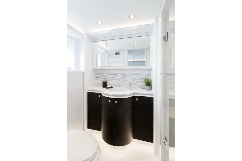 Slide: The Image of Modern yacht bathroom with sleek black vanity, mirrored cabinets, and stylish backsplash, Crescent Semi-Displacement 2019. - 11