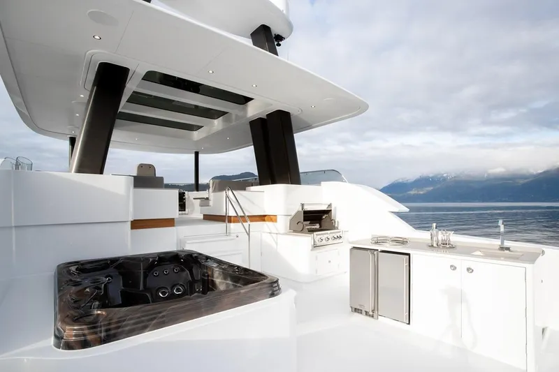 Slide: The Image of Luxurious 2019 Crescent Semi-Displacement yacht deck with hot tub and outdoor kitchen. - 15