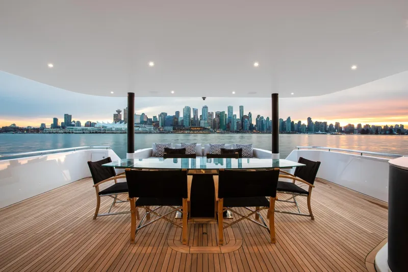 Slide: The Image of Luxurious 2019 Crescent Semi-Displacement yacht deck with city skyline view at sunset. - 2