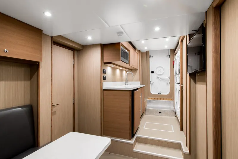 Slide: The Image of Luxurious 2019 Crescent Semi-Displacement yacht interior with modern kitchen and sleek wood finishes. - 20