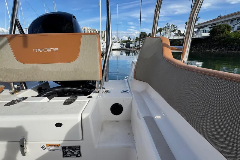 Slide: The Image of 2022 Zodiac Medline 6.8 boat interior with seating, docked in a marina. - 12