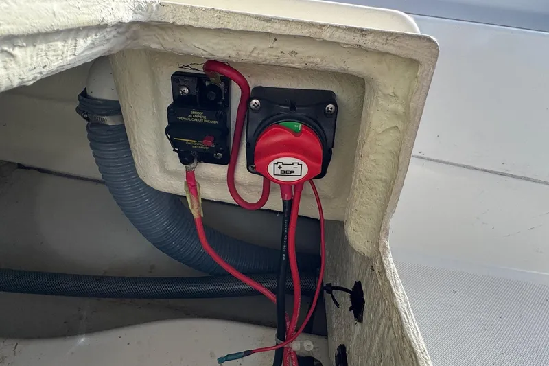 Slide: The Image of Electrical components in a 2022 Zodiac Medline 6.8 boat, featuring a circuit breaker and battery switch. - 15
