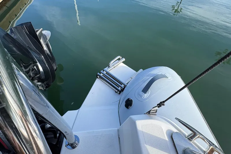 Slide: The Image of 2022 Zodiac Medline 6.8 boat stern with motor and ladder on calm water. - 16