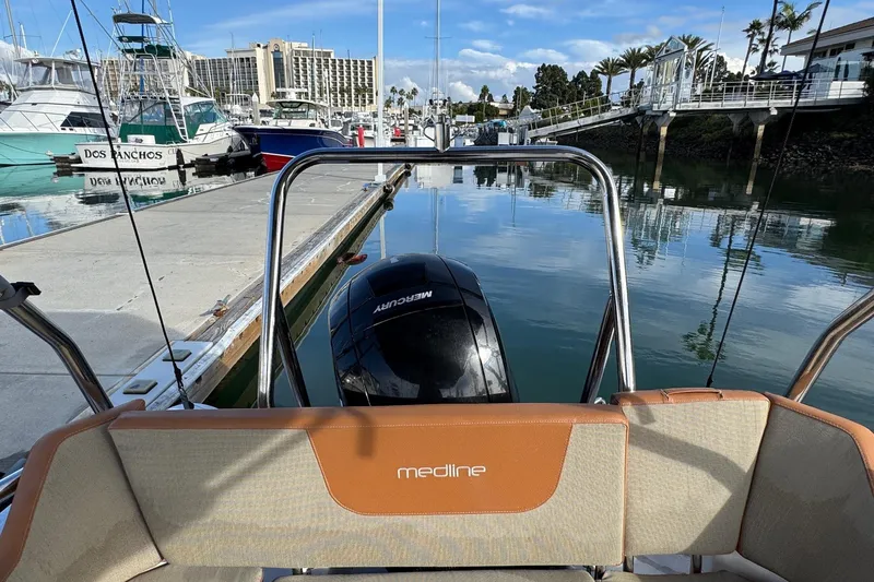 Slide: The Image of 2022 Zodiac Medline 6.8 boat docked at marina with Mercury engine. - 17