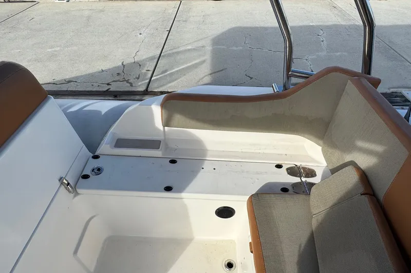 Slide: The Image of 2022 Zodiac Medline 6.8 boat interior with cushioned seating and stainless steel railing. - 19