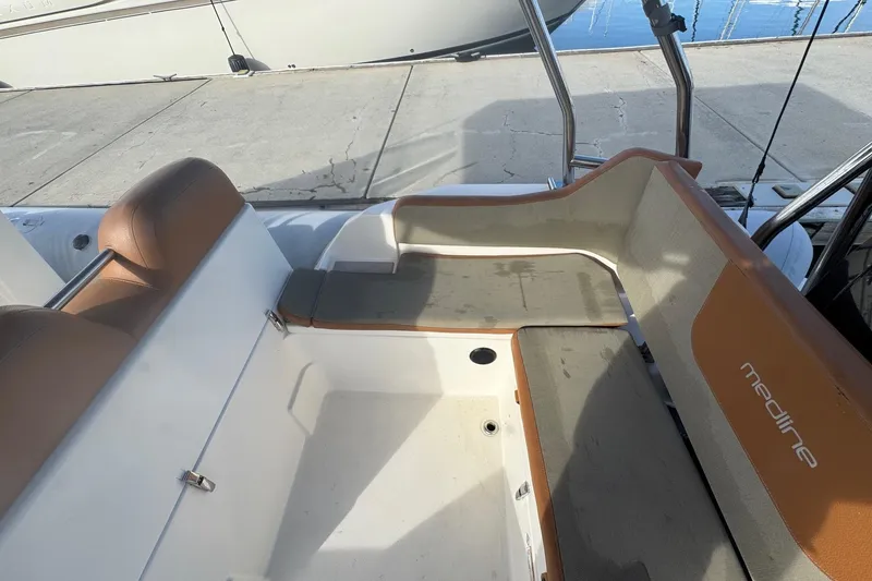 Slide: The Image of 2022 Zodiac Medline 6.8 boat interior with tan seating and white deck. - 21