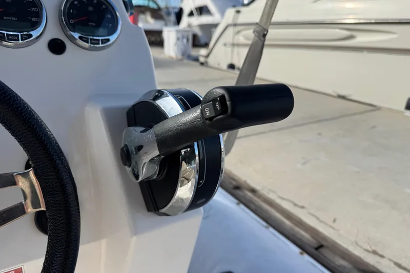 Slide: The Image of Close-up of Zodiac Medline 6.8 boat controls, featuring throttle and gauges, 2022 model. - 25