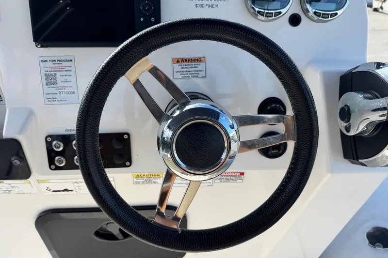 Slide: The Image of Steering wheel of 2022 Zodiac Medline 6.8 boat with control panel and gauges. - 26