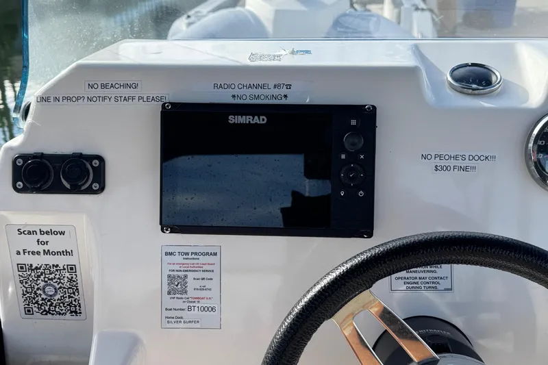 Slide: The Image of Control panel of a 2022 Zodiac Medline 6.8 boat with navigation equipment and safety notices. - 28