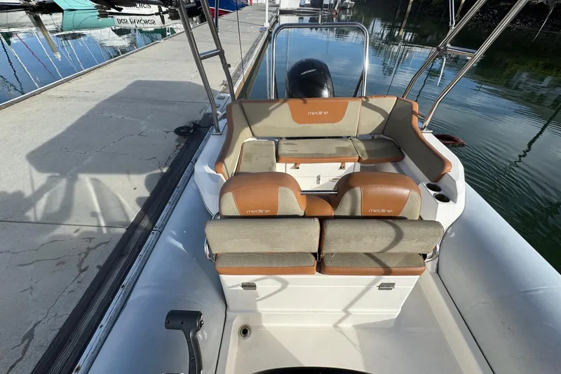 Slide: The Image of 2022 Zodiac Medline 6.8 boat interior with tan seating at dock. - 29