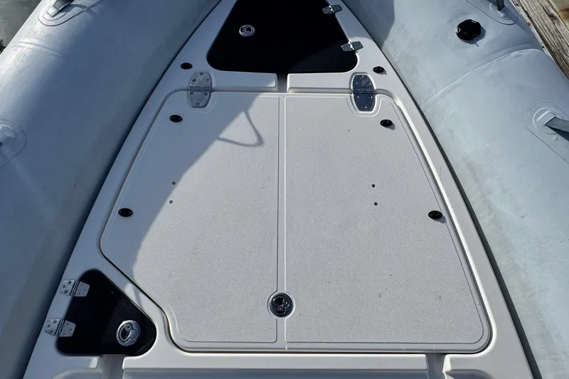 Slide: The Image of 2022 Zodiac Medline 6.8 boat deck with storage compartments and sleek design. - 40