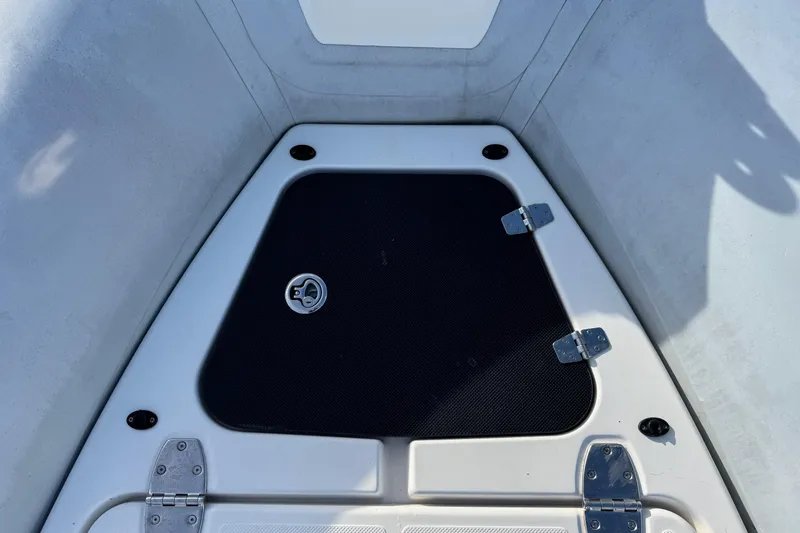 Slide: The Image of 2022 Zodiac Medline 6.8 boat storage compartment with black cover and metal hinges. - 42