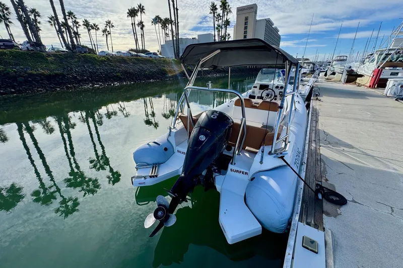 Slide: The Image of 2022 Zodiac Medline 6.8 boat docked in a marina with palm trees. - 7