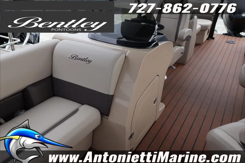 Slide: The Image of 2026 Bentley Pontoons Legacy 223 DL Navigator interior with elegant seating and wood-style flooring. - 9