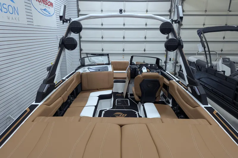 Slide: The Image of 2026 Malibu Wakesetter 21 LX interior with tan upholstery and modern design. - 10