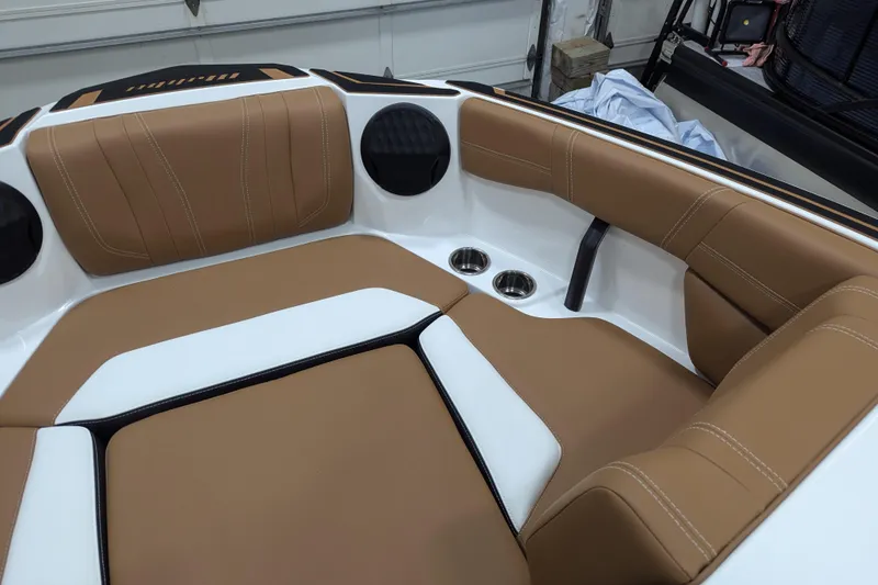 Slide: The Image of 2026 Malibu Wakesetter 21 LX interior with tan and white seating, stylish flooring. - 12