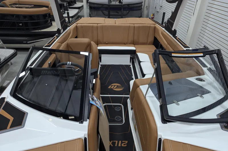 Slide: The Image of 2026 Malibu Wakesetter 21 LX interior with tan seating and cup holders. - 15