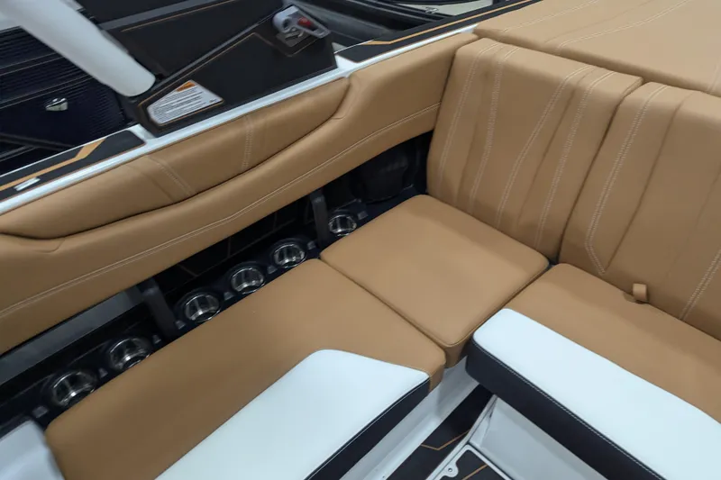 Slide: The Image of 2026 Malibu Wakesetter 21 LX interior with tan leather seating and cup holders. - 19
