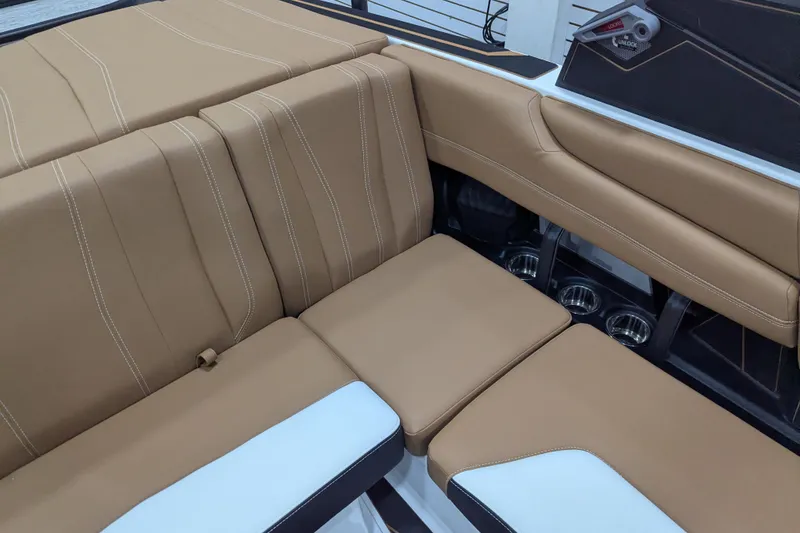Slide: The Image of 2026 Malibu Wakesetter 21 LX interior with tan leather seating and white accent. - 21