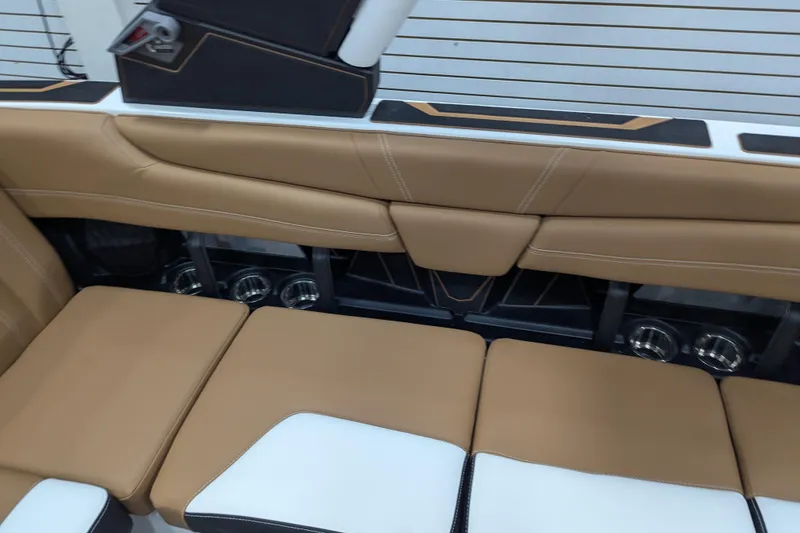 Slide: The Image of 2026 Malibu Wakesetter 21 LX interior with tan leather seating and cup holders. - 22