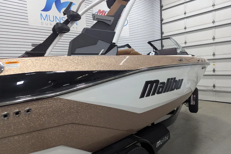 Slide: The Image of 2026 Malibu Wakesetter 21 LX boat in showroom, featuring sleek design and modern features. - 4