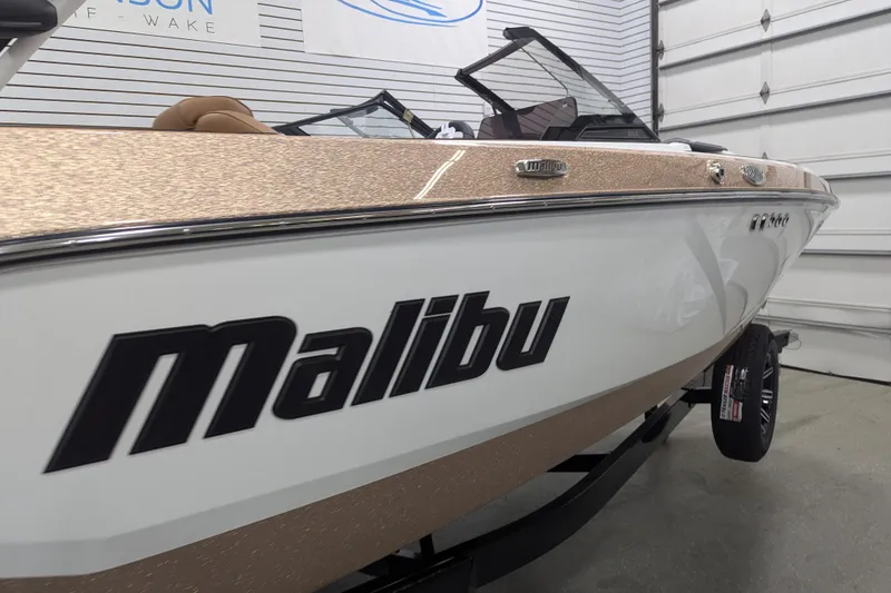 Slide: The Image of 2026 Malibu Wakesetter 21 LX boat in showroom, featuring sleek design and modern features. - 5