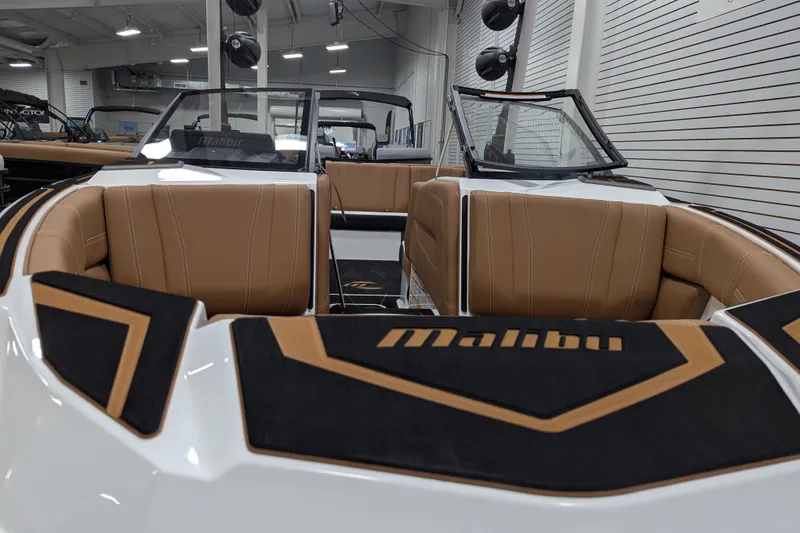 Slide: The Image of 2026 Malibu Wakesetter 21 LX boat displayed indoors at Munson Surf Wake showroom. - 8