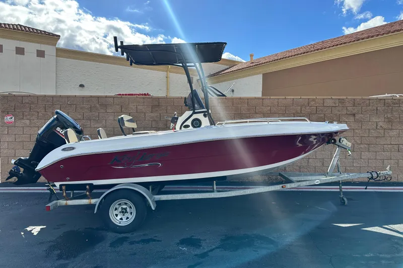 The Image of 2021 Key Largo 1801 boat on trailer, parked outdoors under a sunny sky. - 0