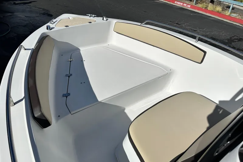 Slide: The Image of 2021 Key Largo 1801 boat with black canvas top, parked outdoors. - 15