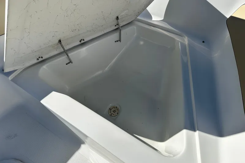 Slide: The Image of 2021 Key Largo 1801 boat interior with seating and Suzuki outboard motor. - 17