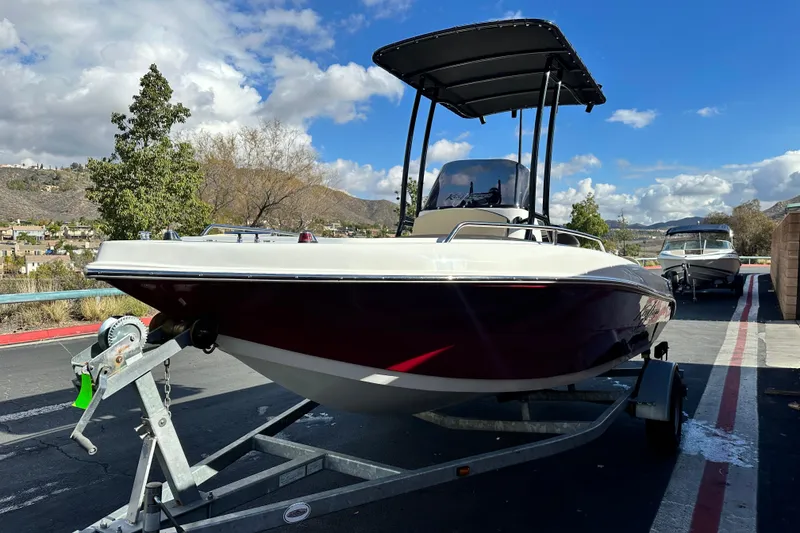 Slide: The Image of 2021 Key Largo 1801 boat with 140 HP engine on trailer, parked outdoors. - 6