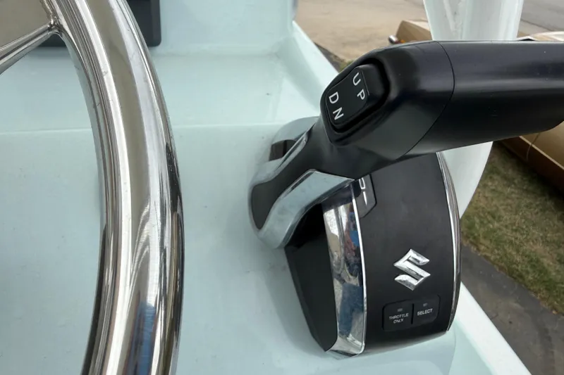 Slide: The Image of Close-up of 2023 Shallow Sport 25 X3 boat throttle control with Suzuki logo. - 12
