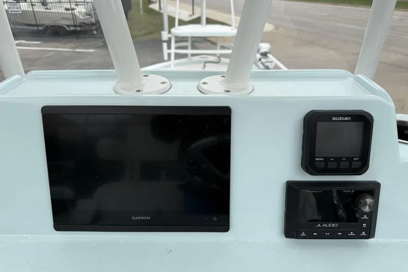 Slide: The Image of 2023 Shallow Sport 25 X3 boat dashboard with Garmin, Suzuki, and JL Audio displays. - 15