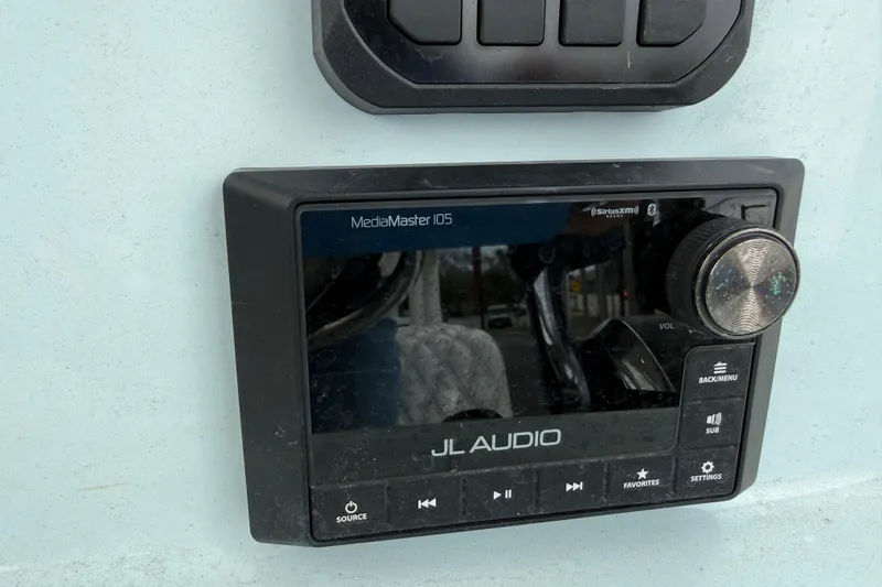 Slide: The Image of JL Audio MediaMaster 105 on 2023 Shallow Sport 25 X3 boat dashboard. - 18