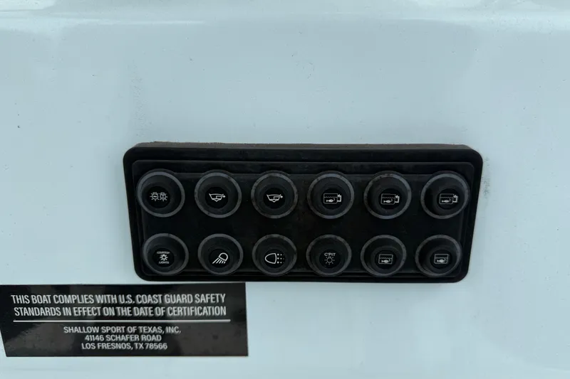 Slide: The Image of Control panel on 2023 Shallow Sport 25 X3 boat with safety compliance label. - 19