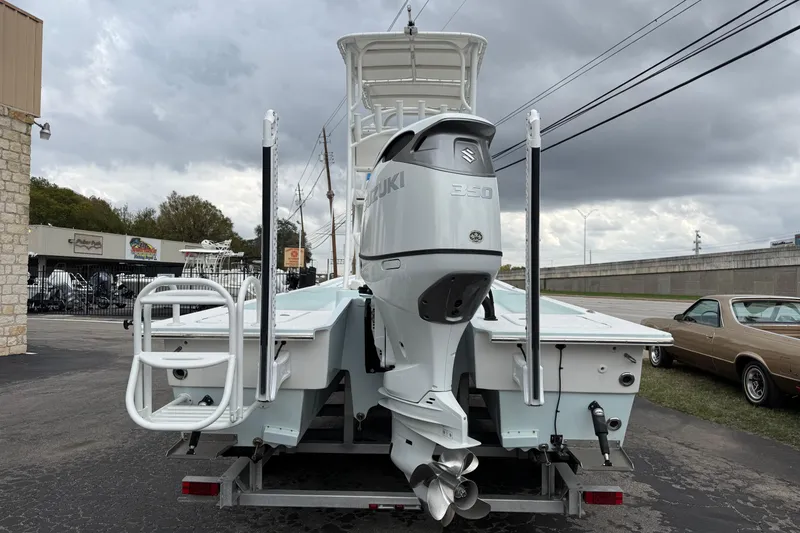 Slide: The Image of 2023 Shallow Sport 25 X3 boat with Suzuki 350 engine on trailer. - 2