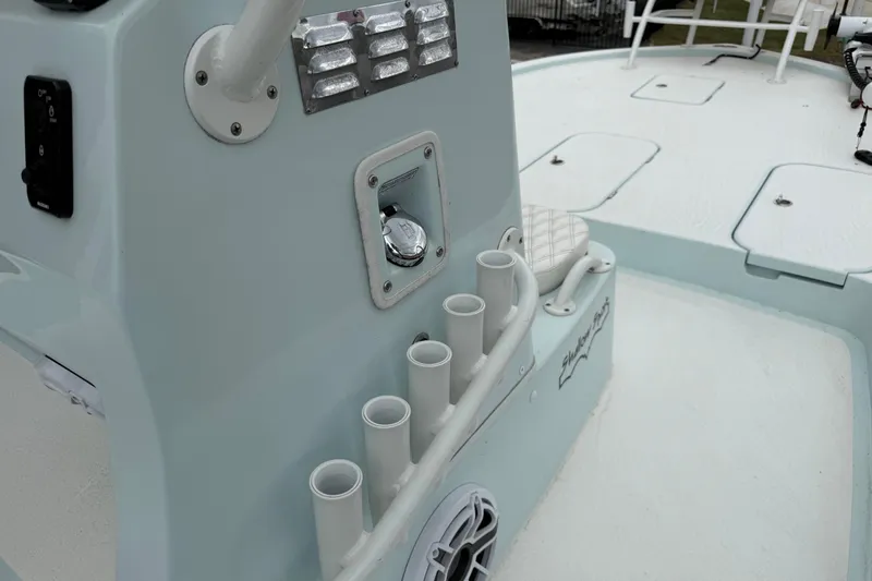 Slide: The Image of 2023 Shallow Sport 25 X3 boat console with rod holders and seating. - 23
