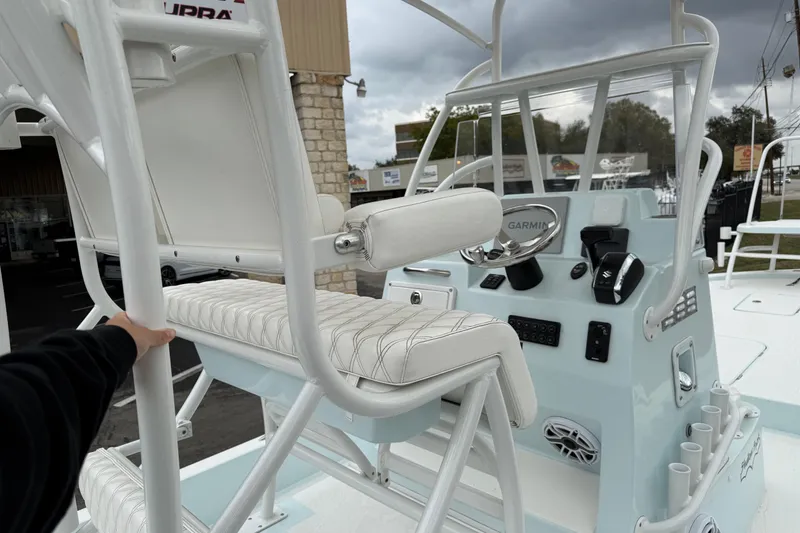 Slide: The Image of 2023 Shallow Sport 25 X3 boat interior with steering console and seating. - 24