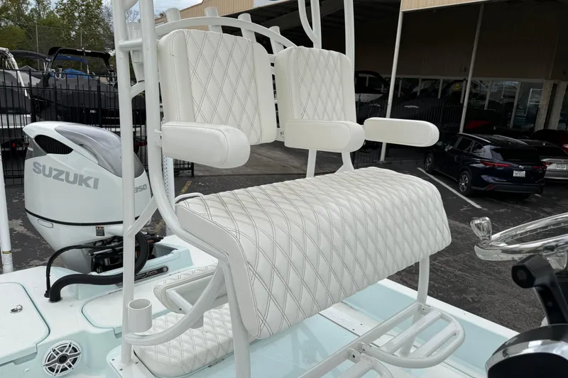 Slide: The Image of 2023 Shallow Sport 25 X3 boat with white seating and Suzuki engine. - 25