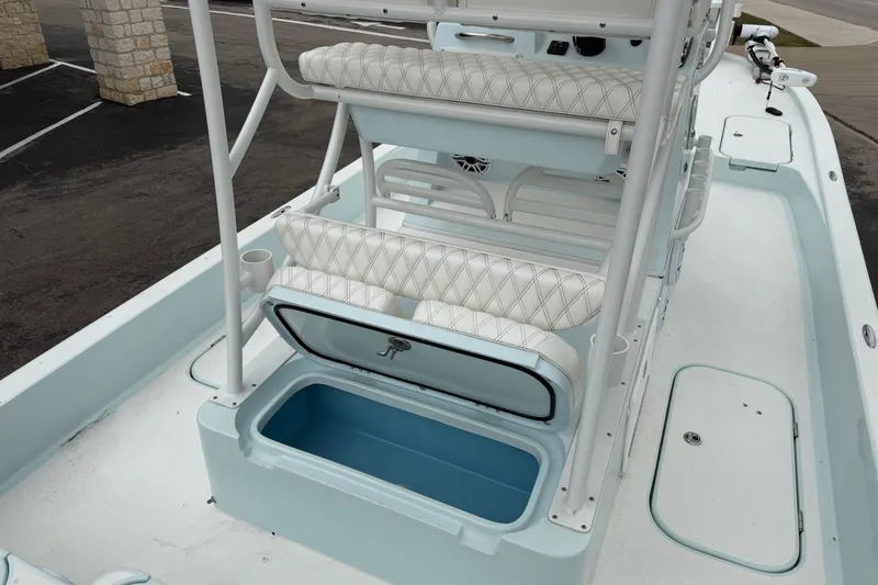 Slide: The Image of 2023 Shallow Sport 25 X3 boat interior with seating and storage compartments. - 30