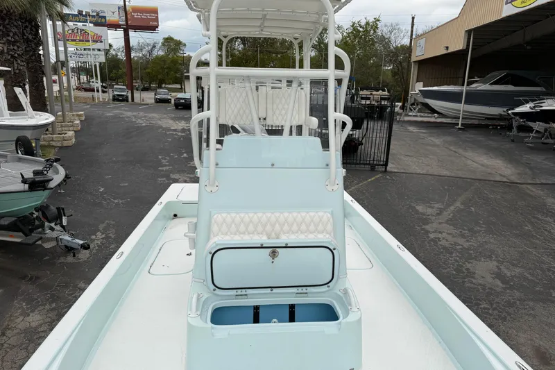 Slide: The Image of 2023 Shallow Sport 25 X3 boat interior with seating and storage compartments. - 31
