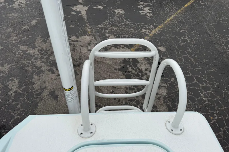 Slide: The Image of 2023 Shallow Sport 25 X3 boat ladder on cracked asphalt surface. - 37