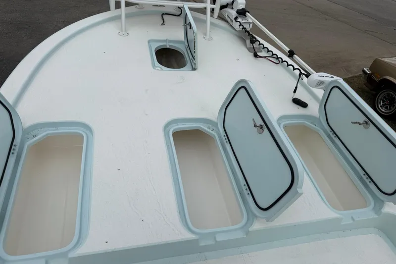 Slide: The Image of 2023 Shallow Sport 25 X3 boat deck with open storage compartments. - 45