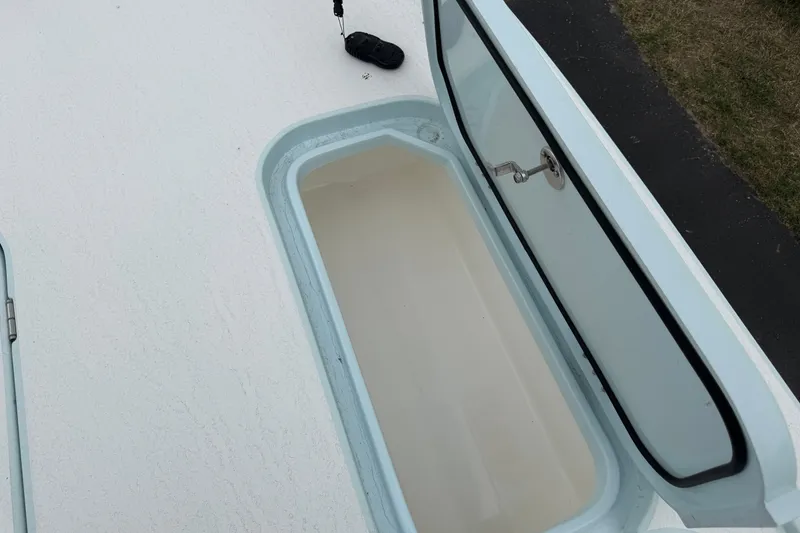 Slide: The Image of Open storage compartment on 2023 Shallow Sport 25 X3 boat deck. - 48