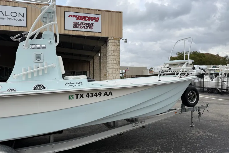 Slide: The Image of 2023 Shallow Sport 25 X3 boat on trailer outside dealership. - 5