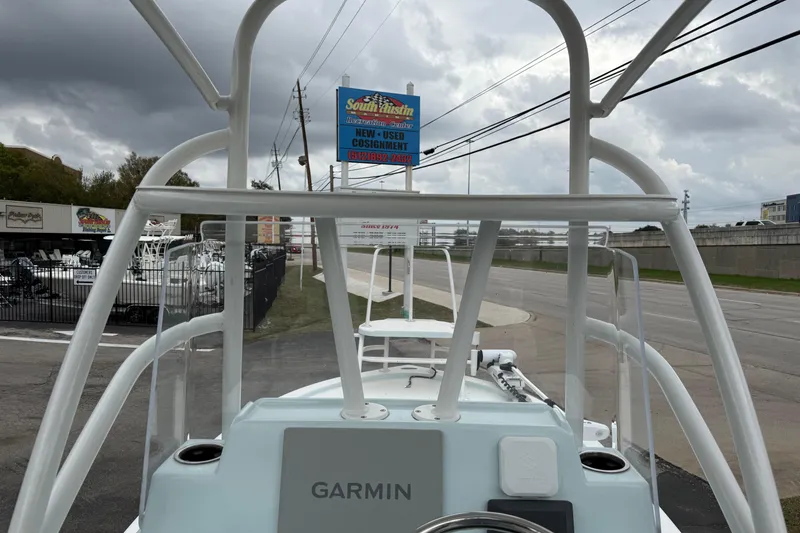 Slide: The Image of 2023 Shallow Sport 25 X3 boat with Garmin equipment, parked near a dealership. - 8