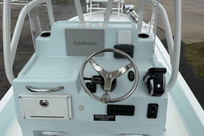 Slide: The Image of 2023 Shallow Sport 25 X3 boat console with Garmin navigation and steering wheel. - 9