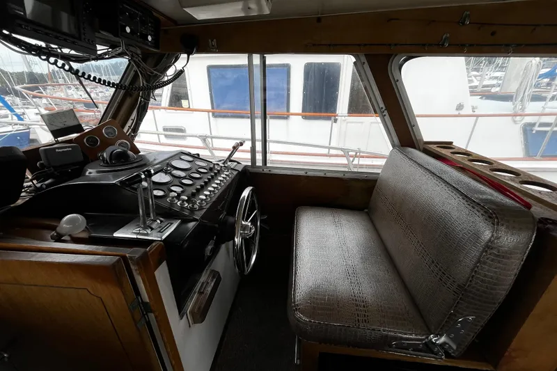 Slide: The Image of 1974 Tollycraft 37 Convertible boat interior with steering wheel and control panel. - 24